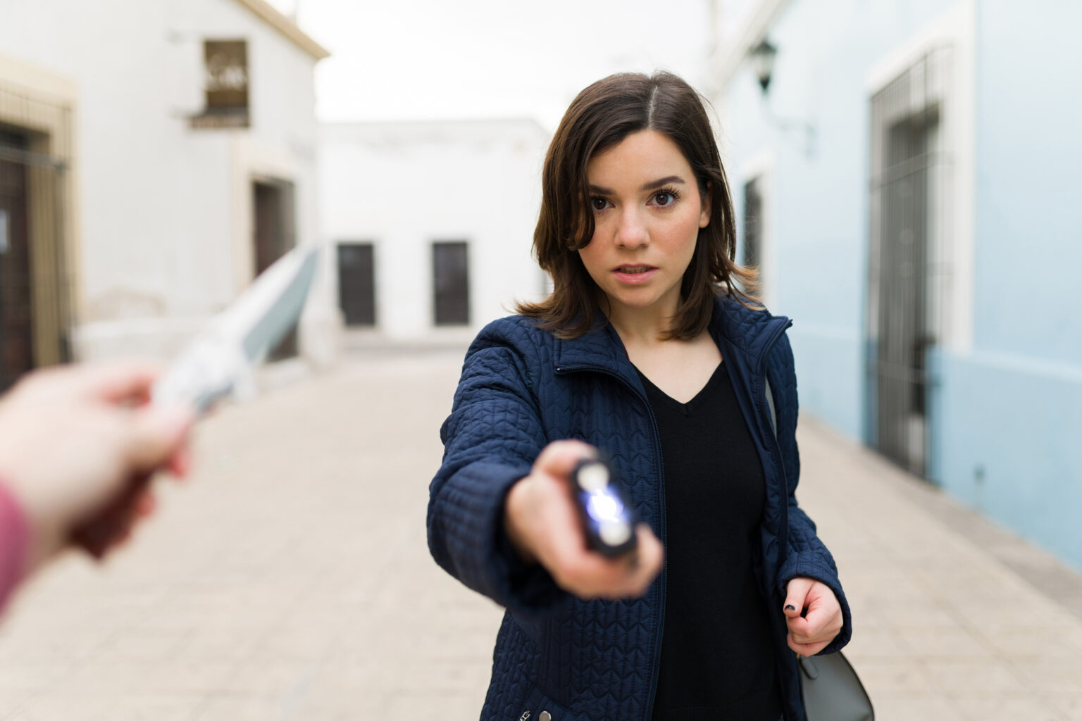 TASER Training - Woman holding taser confronting a personal safety threat.